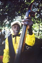 Musician at the Caribbean Music Village. A band musician plays the double bass at the Caribbean