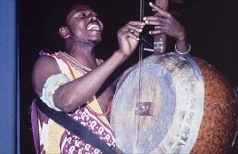 A lute player at the West African Music Village. A musician plays the lute at the West African