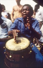 Drummer at the West African Music Village. A musician plays the drums at the West African Music