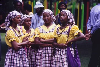 Dancers at the Caribbean Music Village. Four female dancers stand with their arms crossed as they