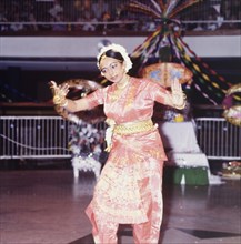 Hindu dancing at a Diwali mela. A female dancer in traditional Indian dress performs at a mela