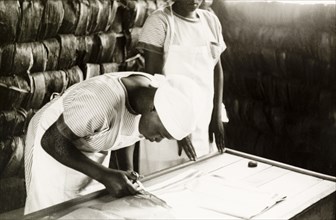 Making garments at a mission school. A Kikuyu student of the Church of Scotland mission school