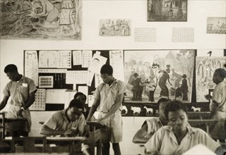 Art class at a teacher training college. Male students work at their desks during an art class at a