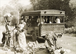 Taxi in the Gold Coast. Plantain sellers and other passengers arrange their loads by the roadside