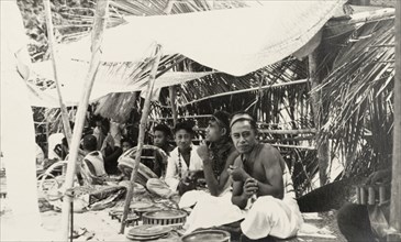 Craft stall at a Fijian market. Fijian craftsmen sit in the shade of canopies as their sell their