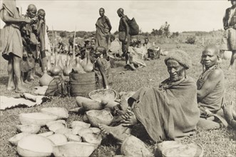 Calabashes on sale at a Kikuyu market. Customers peruse a selection of gourds and calabashes for