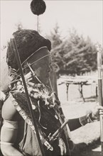 Kikuyu chief in ceremonial dress. Profile shot of a Kikuyu chief wearing full ceremonial dress. He