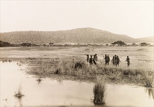 Okiek hunters at Lake Ol Bolossat. A group of Okiek hunters, armed with bows and arrows, search for