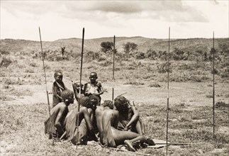 Young Maasai 'morani'. A group of young Maasai 'morani' (warriors) sit closely together on the