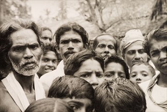 A crowd of Ceylonian men. A crowd of men and boys stare solemnly into the camera. Ceylon (Sri