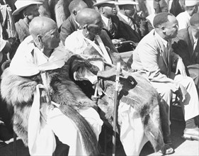 Awaiting the arrival of Princess Elizabeth. African chiefs in ceremonial dress sit on a spectator