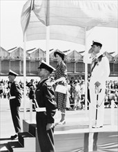 Taking the salute'. Princess Elizabeth and the Duke of Edinburgh stand on a dais to receive a