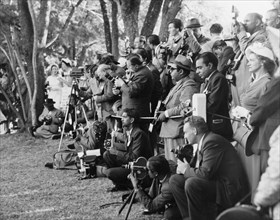 Press at a royal garden party. Photographers and journalists assemble in the grounds of Government