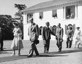 The royal couple leave Government House. Princess Elizabeth and the Duke of Edinburgh walk along a