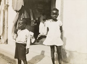 Two Jamaican children. Two young Jamaican children standing on a street in Kingston. Kingston,