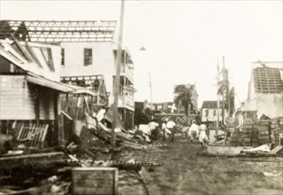 Clearing up debris after a hurricane, Belize. Relief workers begin to clear the rubble from a