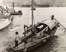 A sampan in Victoria Harbour. A sampan is moored at steps in Victoria Harbour, waiting to ferry