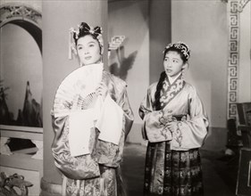Scene from a Chinese opera. Two Chinese actresses perform in an opera at a Hong Kong theatre. One