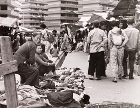 Clothes market in Hong Kong. Street traders display their wares at a busy clothes market. Behind