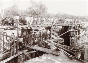 Temporary bridge over Caparo River, Trinidad. Trinidad Government Railway workers pose for a