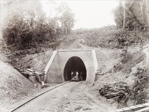 Tunnel on the Caparo Valley line, Trinidad. Trinidad Government Railway workers stand on a