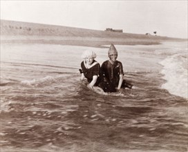 Minnie Murray and friend on a Puri beach. Minnie Murray (right) and a friend sit on a sandy beach