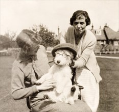 Dressing up the dog. Minnie Murray and her daughter dress up the family's pet dog in a flat cap and