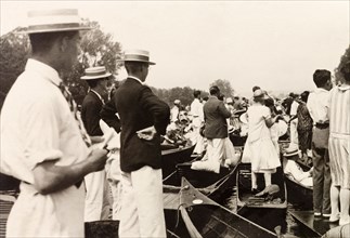 Henley Royal Regatta, 1929. Spectators gather on punts on the River Thames to watch a boat race at