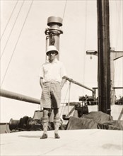 James Murray on deck of S.S. Domala. James Murray stands on the deck of the passenger liner S.S.