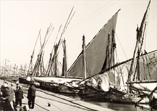 Docks on Suez Canal. Rows of sail boats are moored at docks on the Suez Canal. Suez, Egypt, 1930.