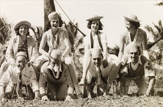 Fun and games during a picnic, Calcutta. Portrait of a group of British friends joking around