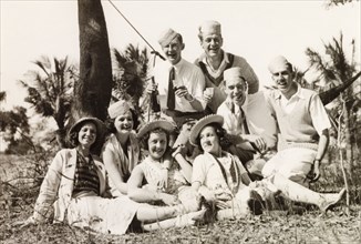 Friends enjoying a picnic, Calcutta. A group of British friends pose for a portrait during a picnic
