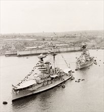 Ships decorated for Empire Day, Malta. Two large steamships leave Grand Harbour in Valetta,