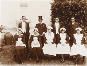 Household staff, St Helena. Outdoors portrait of the uniformed household staff of a colonial