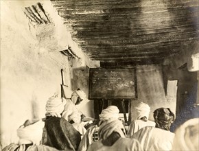 Adult students in a classroom, Kano. Adult students take notes from the blackboard during a lesson