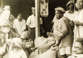 Weighing sacks of cocoa. Sacks of cocoa are weighed at a cooperative warehouse in preparation for