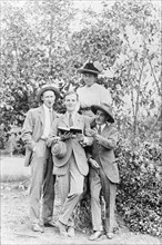 Denys Finch-Hatton with friends . Four European friends pose for an informal portrait outdoors. An