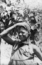 One of Chief Murigo's 19 wives'. Portrait of a Kikuyu woman, wearing several items of jewellery