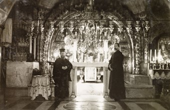 Calvary Altar, Jerusalem. Two monks stand beside the ornate Calvary Altar in the Church of the Holy