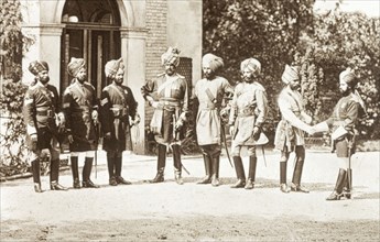 Sikh officers loyal to the British Army. Eight Sikh officers stand in the driveway of a colonial