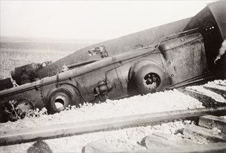 Derailment at Ras el Ain. A steam locomotive lies upturned on a railway embankment, derailed in a