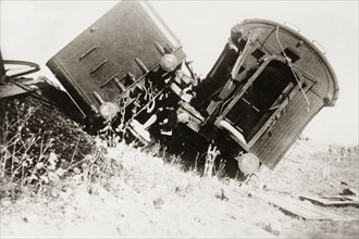 Derailed carriages at Ras el Ain. Two railway carriages lie upturned on a railway embankment,