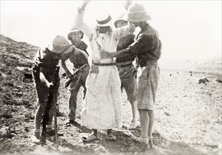 British soldiers searching a Palestinian Arab. Four British soldiers perform a body search on a