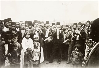 A traditional Arab wedding. Group portrait of male guests, children and musicians at a traditional