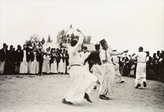 Dancing at an Arab wedding, Palestine. Several men perform a traditional dance at an Arab wedding,