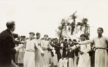 Dancing at an Arab wedding, Palestine. Several men perform a traditional dance at an Arab wedding.