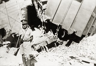 Guarding a derailment on the Kantara line. A British soldier guards the wreckage of a train on the