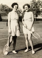 Playing tennis, Calcutta, 1935. Two American women, Mildred and Helen, pose with their racquets on