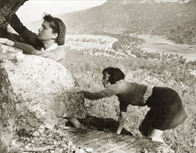 Climbing in Burragorang Valley. Two European women climb a cliff face in Burragorang Valley whilst