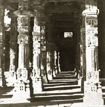 Carved pillars at the Quwwat-ul-Islam Mosque. Intricately carved stone pillars line a passageway at
